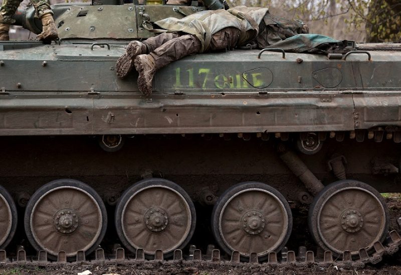 SENSITIVE MATERIAL. THIS IMAGE MAY OFFEND OR DISTURB Ukrainian servicemen use a tank to recover the body of a fallen soldier after heavy fighting at the frontline of Bakhmut near Chasiv Yar, Ukraine, April 9, 2023. REUTERS/Kai Pfaffenbach