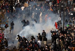 People react amid tear gas during clashes at a demonstration as protester gather on Place de la Bastille as part of the 12th day of nationwide strikes and protests against French government's pension reform, in Paris, France, April 13, 2023. REUTERS