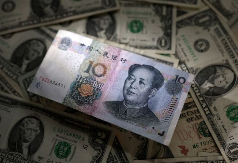 Chinese Yuan and U.S. dollar banknotes are seen in this illustration taken March 10, 2023. REUTERS