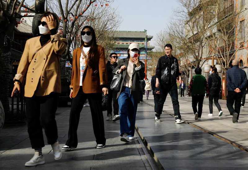 People walk at the tourism site of Qianmen street, in Beijing, China March 14, 2023. REUTERS/Tingshu Wang