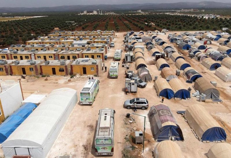 Buses turned into traveling classrooms pull into at a displacement camp in Jindayris in the opposition-held northwestern Syrian province of Aleppo on May 23, 2023, following a devastating earthquake more than three months ago. (AFP)
