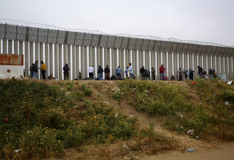 Migrants camp between the two border fences as they wait for authorities to request asylum in San Ysidro, California, U.S., as seen from Tijuana, Mexico April 30, 2023. REUTERS/Jorge Duenes