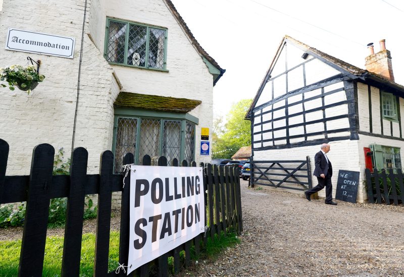 A man walks near The Brocket Arms pub which is acting as a polling station for local elections in Ayot St Lawrence, Britain, May 4, 2023. REUTERS/Peter Cziborra