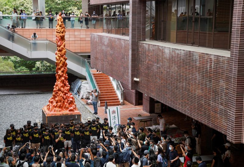University students observe a minute of silence in front of the “Pillar of Shame” statue at the University of Hong Kong on the 32nd anniversary of the crackdown on pro-democracy demonstrators at Beijing's Tiananmen Square in 1989, in Hong Kong, China June 4, 2021. REUTERS/Lam Yik