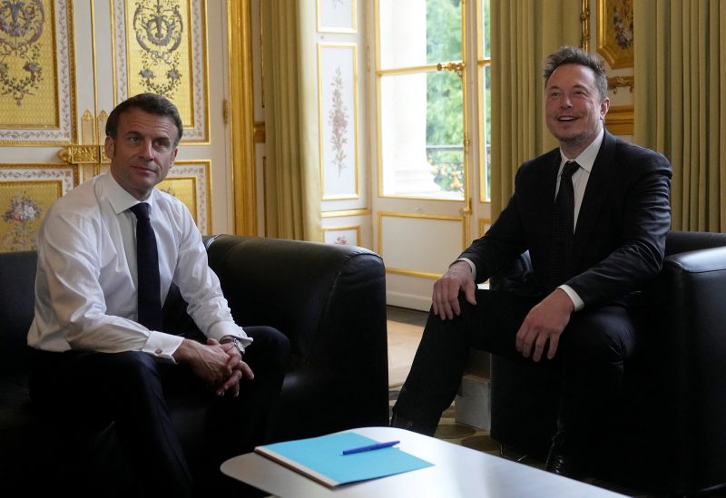 Twitter, X Corp., and Tesla CEO Elon Musk poses with French President Emmanuel Macron prior to their talks, Monday, May 15, 2023 at the Elysee Palace in Paris, France. Michel Euler/Pool via REUTERS