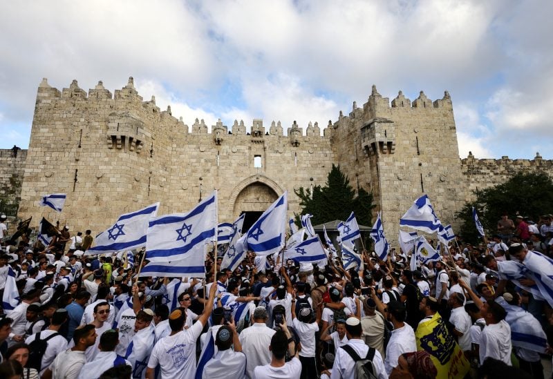 Israelis sing and dance with flags by Damascus gate to Jerusalem's Old city as they mark Jerusalem Day, in Jerusalem May 18, 2023. REUTERS/Ronen Zvulun