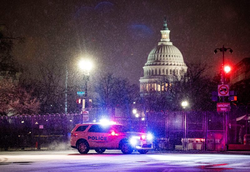 A Metropolitan Police Department car drives through the snow on Capitol Hill in Washington, U.S., January 25, 2021. REUTERS/Al Drago
