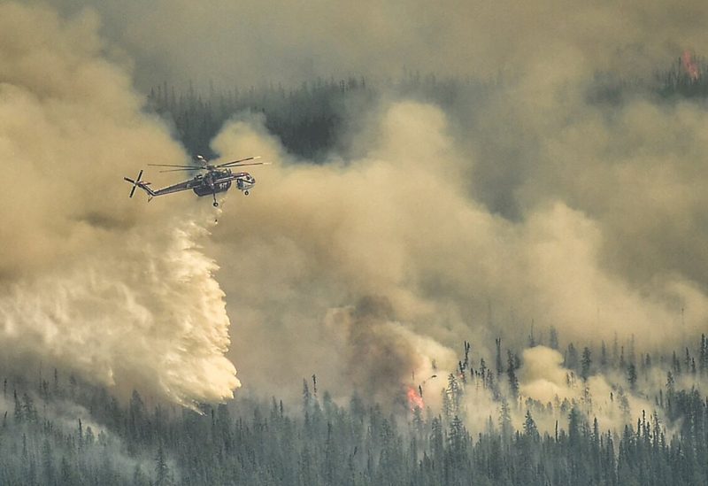 A Sky crane helicopter dumps water on the Eagle Wildfire Complex near Fox Creek, Alberta, Canada May 19, 2023. Alberta Wildfire/Handout via REUTERS