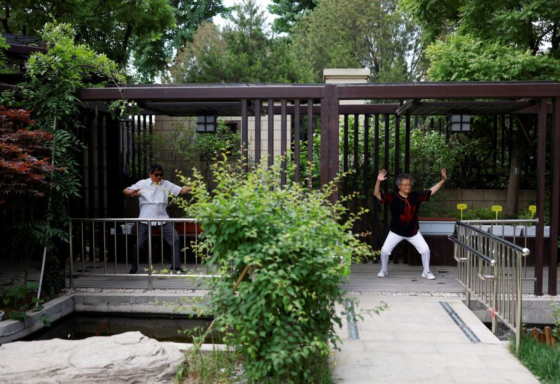 Wang Yiguang, 85, and her husband Yang Hou, 86, exercise outdoor at Heyuejia, a care home for the elderly, in Beijing, China May 26, 2021. Picture taken May 26, 2021. REUTERS/Carlos Garcia Rawlins