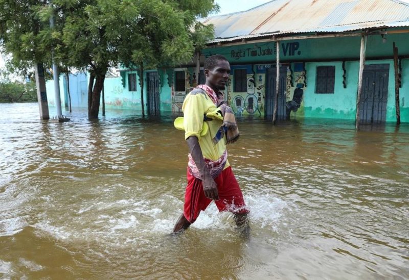 A man walks through floodwater in Beledweyne, central Somalia, on May 13, 2023. (AFP)