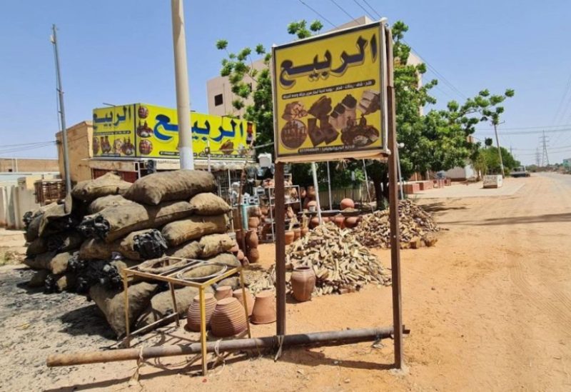 Bags of charcoal are sold on the side of a street in Khartoum to be used as fighting between rival Sudanese generals continues, on May 13, 2023. (AFP)