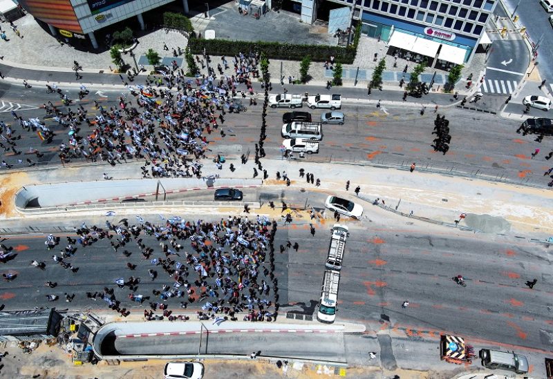 An aerial view shows protesters in front of a line of police as they demonstrate on 'Day of Equality' in protest against Israeli Prime Minister Benjamin Netanyahu and his nationalist coalition government's judicial overhaul, in Tel Aviv, Israel May 4, 2023. REUTERS/Ilan Rosenberg