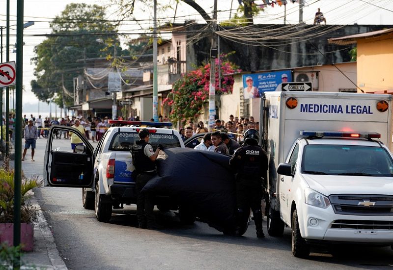 FILE PHOTO: Police officers cover a crime scene where colleagues were killed in response to prisoner transfers from overcrowded prisons, prompting President Guillermo Lasso to declare a state of emergency in two provinces, in Guayaquil, Ecuador November 1, 2022. REUTERS/Santiago Arcos/File Photo