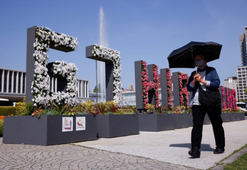 A woman walks past a “G7 Hiroshima” flower installation near the Peace Memorial Museum, ahead of the G7 summit, in Hiroshima, Japan, May 17, 2023. REUTERS