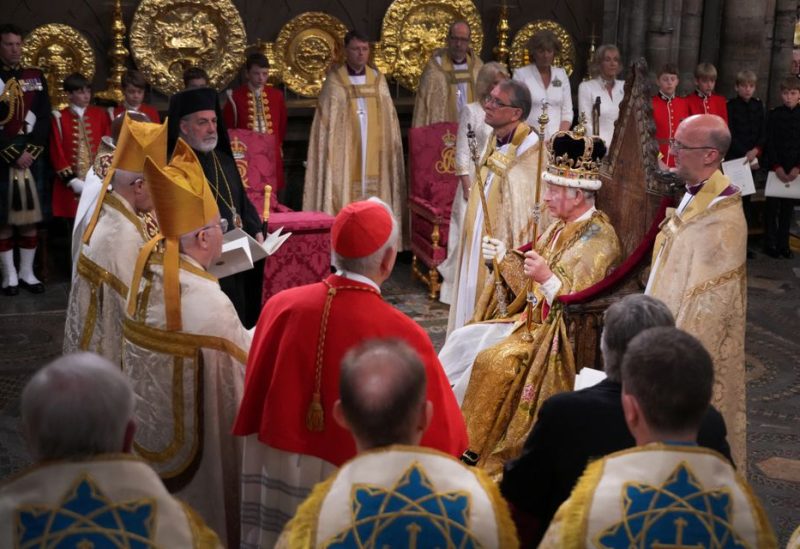 King Charles III, wearing St Edward's Crown, surrounded by faith leaders during his coronation ceremony in Westminster Abbey, London. Picture date: Saturday May 6, 2023. Victoria Jones/Pool via REUTERS