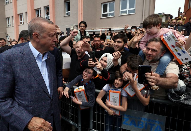Turkish President Tayyip Erdogan greets his supporters after he casts his ballot at a polling station in Istanbul, Turkey, May 14, 2023. Murat Cetinmuhurdar/PPO/Handout via REUTERS