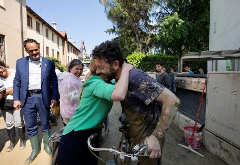 Italian Prime Minister Giorgia Meloni hugs a man during her visit to flood-hit Faenza, Italy, May 21, 2023. Palazzo Chigi Press Office/Handout via REUTERS NO RESALES. NO ARCHIVES. EDITORIAL USE ONLY. THIS IMAGE HAS BEEN SUPPLIED BY A THIRD PARTY. MANDATORY CREDIT.