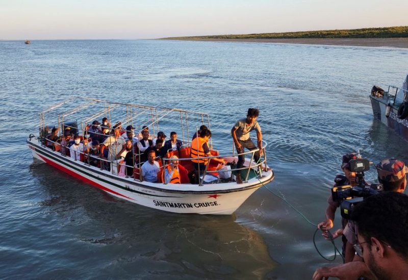 Some Rohingya Muslim refugees and Bangladeshi officials on a boat return after visiting Myanmar's Rakhine State as part of an effort to encourage their voluntary repatriation, in Teknaf, Cox's Bazar, Bangladesh, May 5, 2023. REUTERS