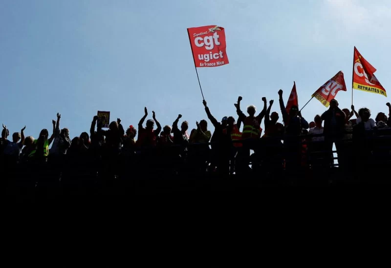 Protesters, holding CGT labour union flags, attend a demonstration during the ninth day of nationwide strikes and protests against French government's pension reform, in Nice, France, March 23, 2023. REUTERS