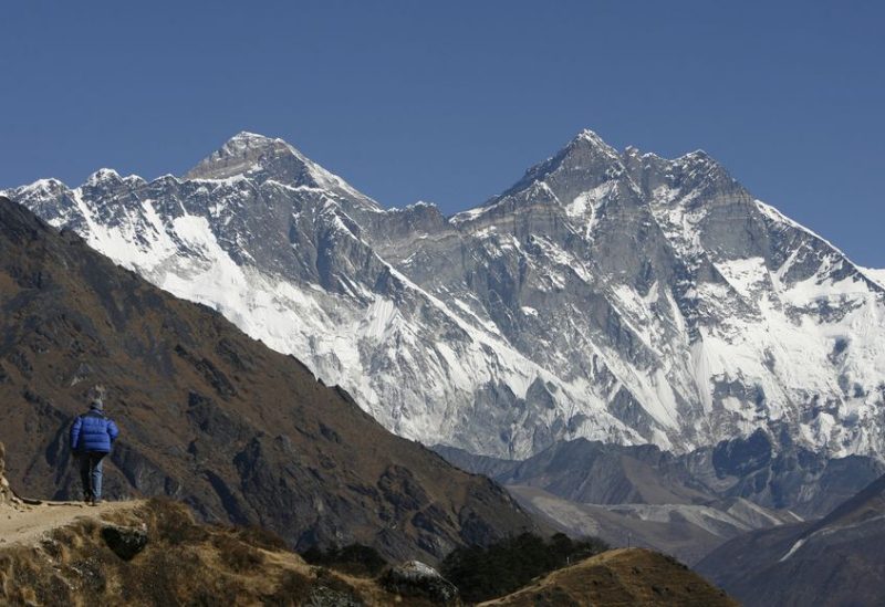 A tourist looks at a view of Mt. Everest from the hills of Syangboche in Nepal December 3, 2009. REUTERS