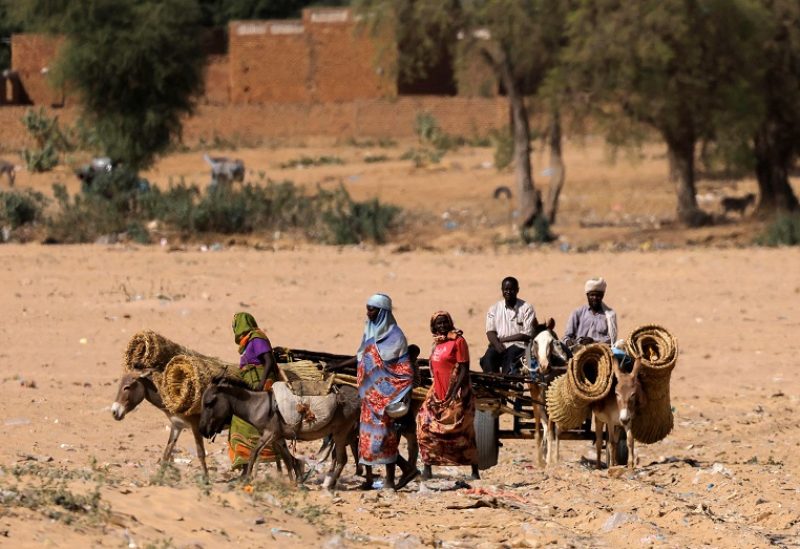 Sudanese refugee women, who fled the violence in their country, are seen crossing the border between Sudan and Chad, in Koufroun, Chad May 6, 2023. REUTERS/Zohra Bensemra 