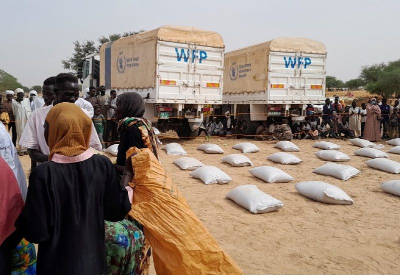 Sudanese refugees who have fled the violence in their country queue to receive food supplements from World Food Programme (WFP) near the border between Sudan and Chad in Adre, Chad April 26, 2023. REUTERS/Mahamat Ramadane