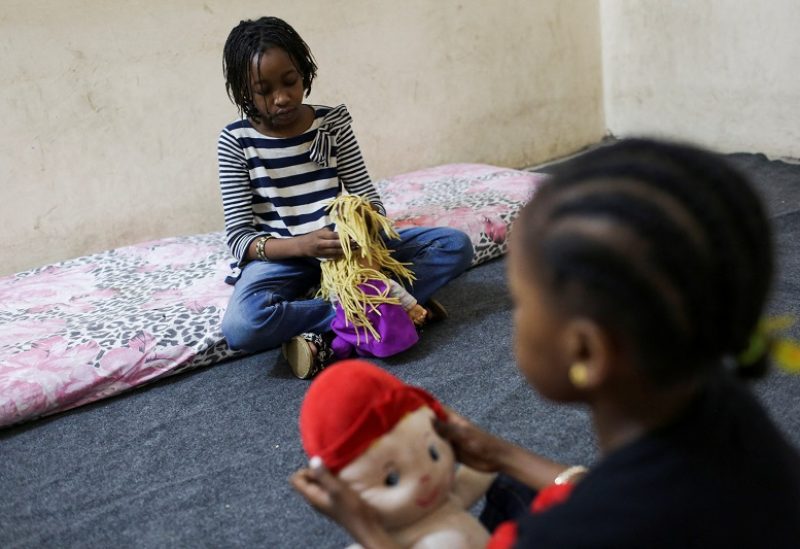 Sudanese displaced woman Sanaa Mahmoud's daughters Talia and Talien, who fled after the last crisis in Sudan's capital Khartoum, play during an interview with Reuters as they stay at a shelter in the district of Boulaq Al-Dakrour in Giza, Egypt May 13, 2023. REUTERS/Hadeer Mahmoud