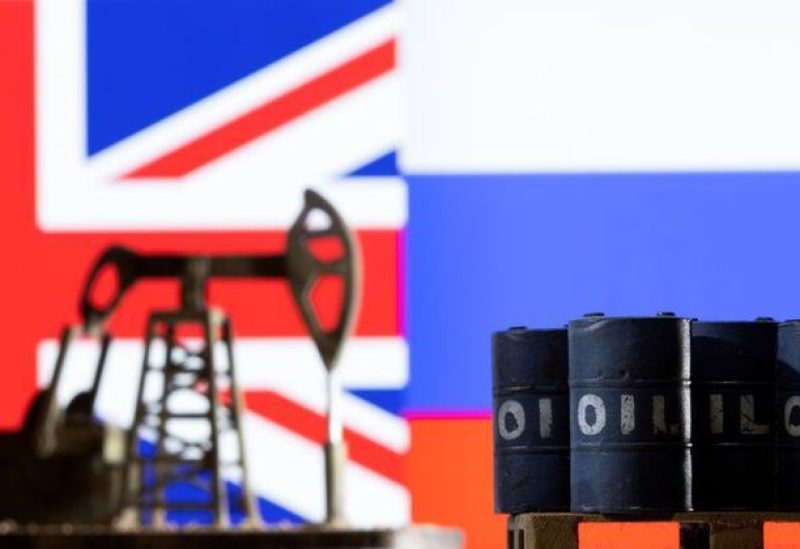 Models of pump jack and oil barrels are seen in front of the displayed UK and Russia flag colours in this illustration taken March 8, 2022. REUTERS/Dado Ruvic/Illustration
