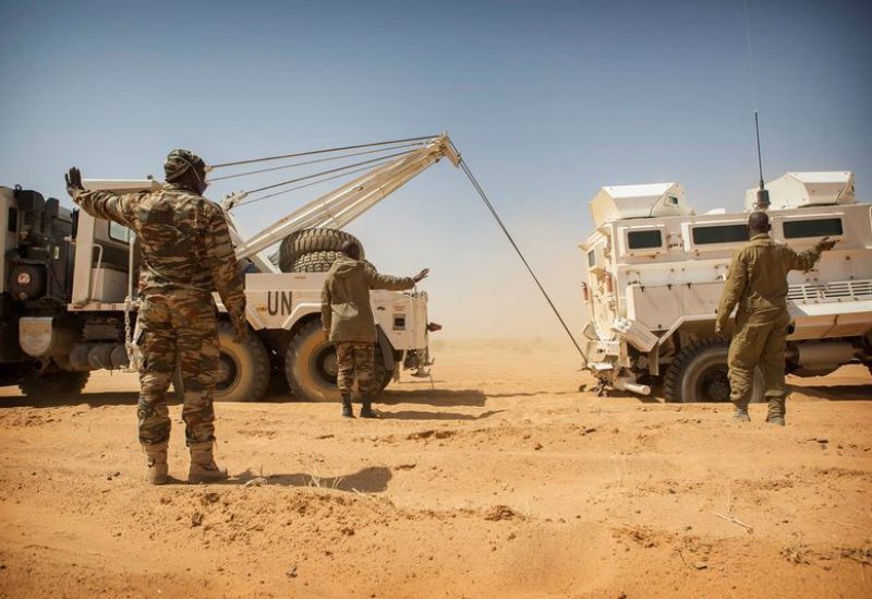 Members of the MINUSMA Guinean contingent pull their stranded escort vehicle during a logistic convoy from Gao to Kidal, Mali February 17, 2017. Each month MINUSMA organizes logistic convoys involving hundreds of civilians and military vehicles to supply remote UN bases in northern Mali. Picture taken February 17, 2017. MINUSMA/Sylvain Liechti handout via REUTERS