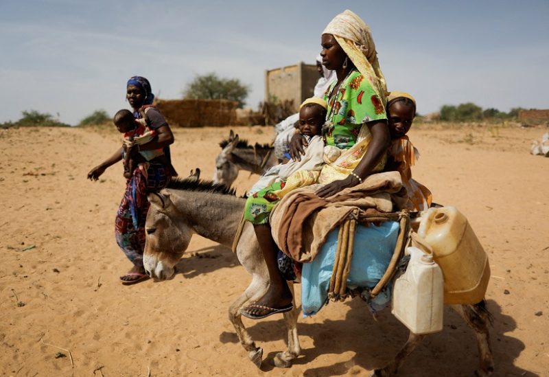 Hawa Adam, a Sudanese refugee woman, who fled the violence in Sudan's Darfur region, rides a donkey with her children as she heads to water point near the border between Sudan and Chad in Goungour, Chad May 8, 2023. REUTERS/Zohra Bensemra TPX IMAGES OF THE DAY