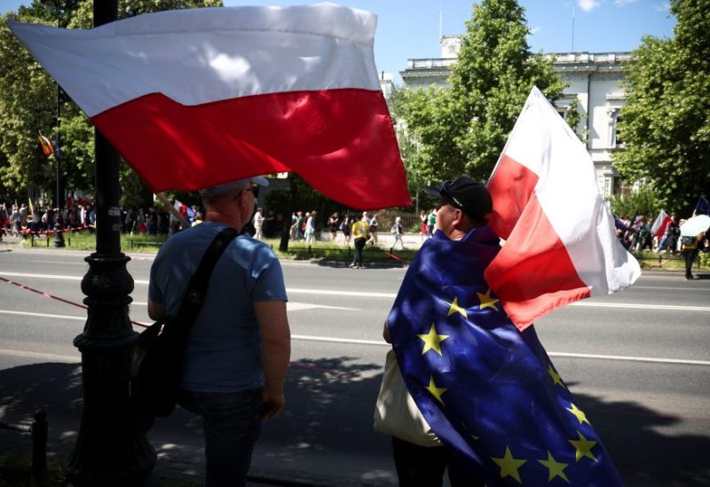 People wait for a march organised by main opposition party the Civic Platform (PO) on the 34th anniversary of the first democratic elections in postwar Poland, in Warsaw, Poland, June 4, 2023. REUTERS/Kacper Pempel