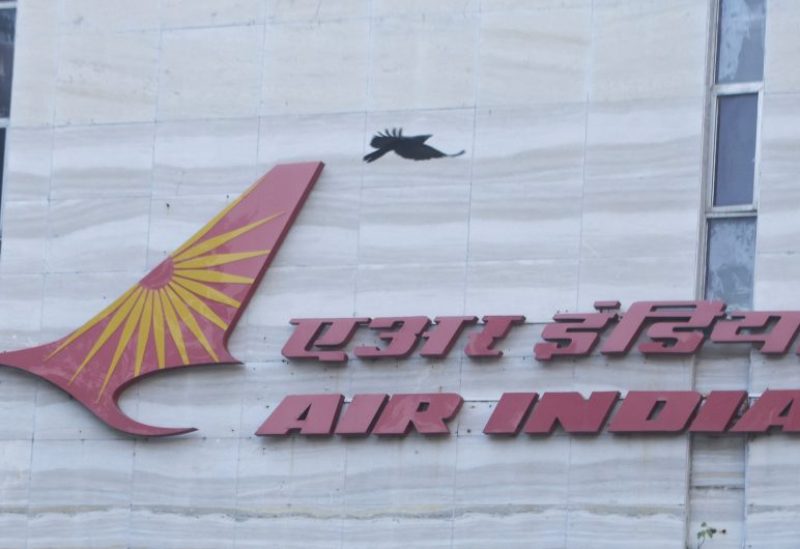 A bird flies over a logo of Air India airlines at the corporate headquarters in Mumbai, India, October 19, 2021. REUTERS/Francis Mascarenhas/