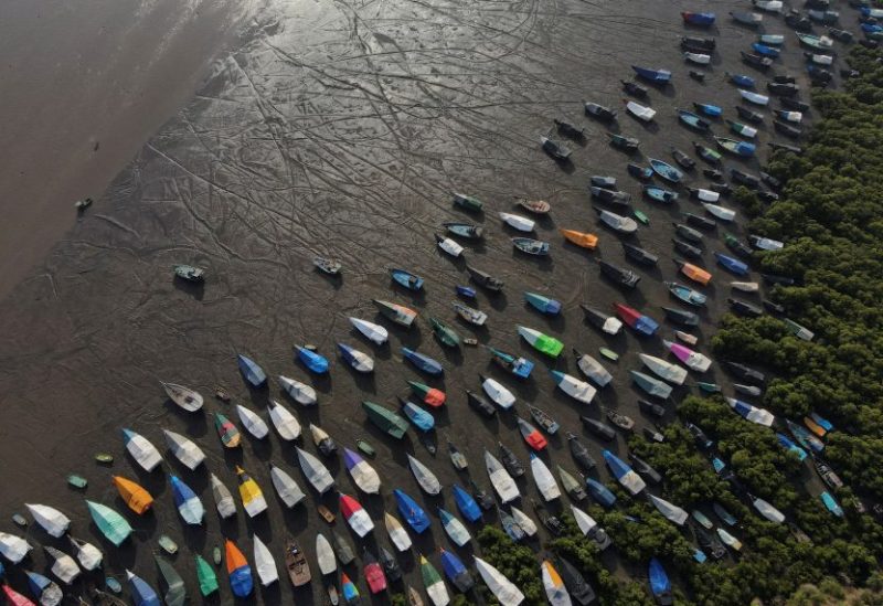 An aerial view of fishing boats covered with tarpaulin sheets parked on the shore, before the start of the monsoon season, on the outskirts of Mumbai, India, June 8, 2023. REUTERS/Francis Mascarenhas