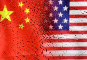 U.S. and Chinese flags are seen through broken glass in this illustration taken, January 30, 2023. REUTERS/Dado Ruvic/Illustration/File Photo