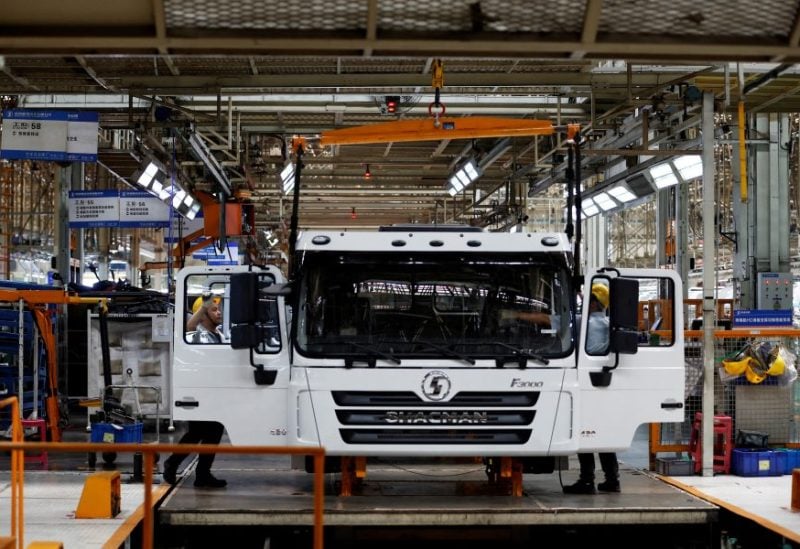 Employees work on the trucks production line during an organised media tour to the Shaanxi Automobile Group factory in Xian, Shaanxi province, China May 17, 2023. REUTERS/Florence Lo/File Photo