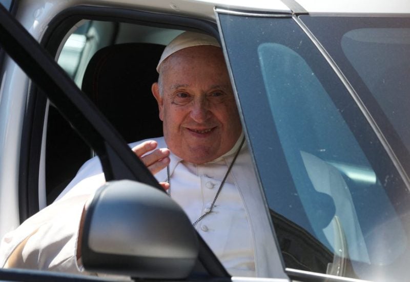 Pope Francis waves as he rides in a car near the Vatican on the day of his discharge from Gemelli hospital in Rome, Italy, June 16, 2023. REUTERS/Yara Nardi