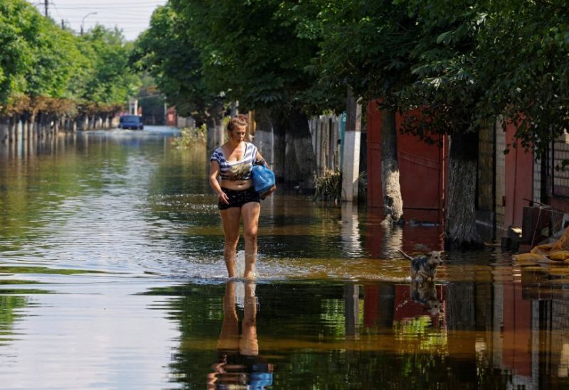 A woman walks along a street after floodwaters receded following the collapse of the Nova Kakhovka dam in the course of Russia-Ukraine conflict, in the town of Hola Prystan in the Kherson region, Russian-controlled Ukraine, June 16, 2023. REUTERS/Alexander Ermochenko