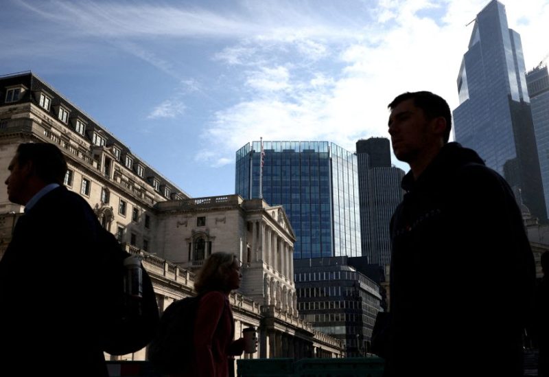 People walk outside the Bank of England in the City of London financial district in London, Britain May 11, 2023. REUTERS/Henry Nicholls//File Photo