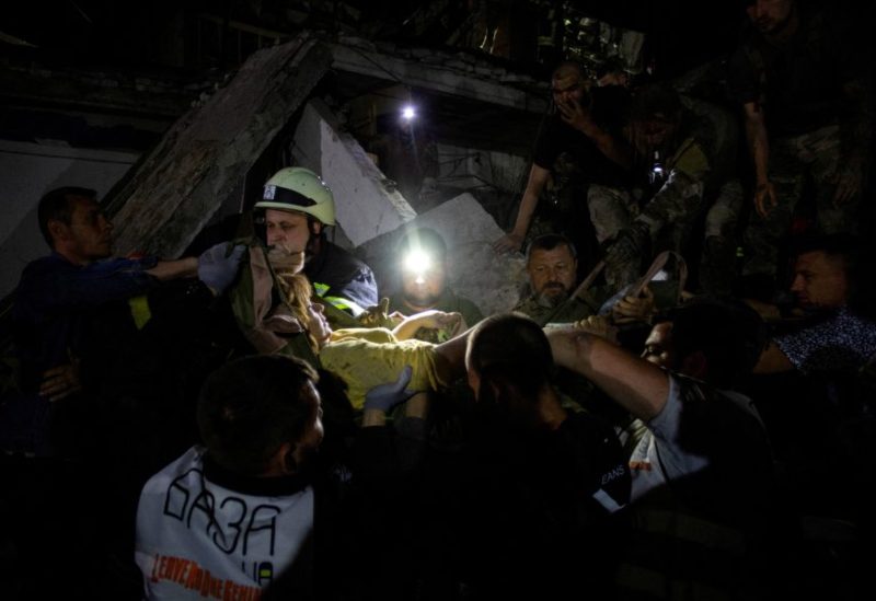 Rescues and volunteers carry a woman rescued from the debris at the site of hotel and restaurant buildings heavily damaged by a Russian missile strike, in central Kramatorsk, Donetsk region, Ukraine. REUTERS/Oleksandr Ratushniak