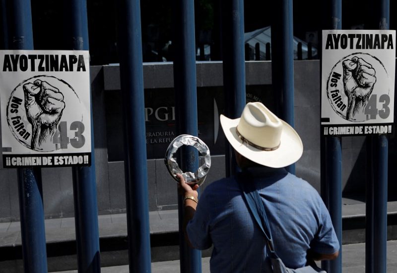 FILE PHOTO: A relative of one of the 43 missing students of Ayotzinapa College Raul Isidro Burgos takes part in a protest to demand the removal of Director of Criminal Investigations,Tomas Zeron, outside the Attorney General's Office (PGR) headquarters in Mexico City, Mexico May 20, 2016. The words on the posters read, "Ayotzinapa - We are missing 43". REUTERS/Henry Romero/File Photo