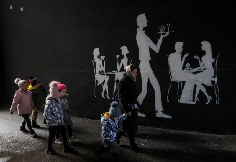 A kindergarten employee leads children to a bomb shelter during an air raid, amid Russia's attack on Ukraine, in central Kyiv, Ukraine March 7, 2023. REUTERS
