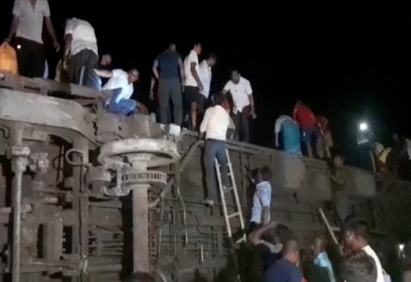 People try to escape from toppled compartments, following the deadly collision of two trains, in Balasore, India June 2, 2023, in this screen grab obtained from a video. ANI/Reuters TV via REUTERS THIS IMAGE HAS BEEN SUPPLIED BY A THIRD PARTY. NO RESALES. NO ARCHIVES INDIA OUT. NO COMMERCIAL OR EDITORIAL SALES IN INDIA