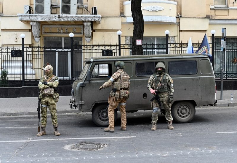 Fighters of Wagner private mercenary group stand guard outside the headquarters of the Southern Military District in the city of Rostov-on-Don, Russia, June 24, 2023. REUTERS/Stringer