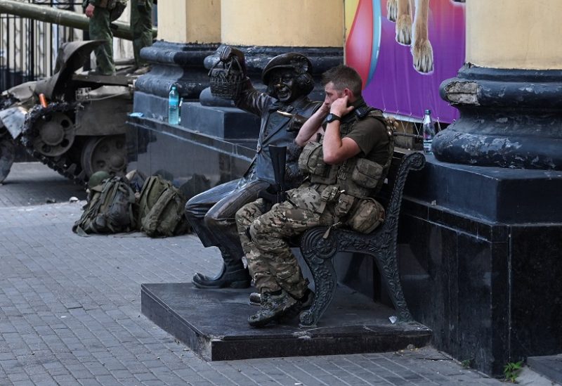 A fighter of Wagner private mercenary group sits on a bench outside a local circus near the headquarters of the Southern Military District controlled by Wagner fighters in the city of Rostov-on-Don, Russia, June 24, 2023. REUTERS/Stringer