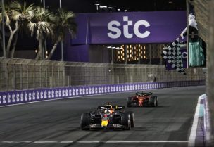 Red Bull's Dutch driver Max Verstappen (foreground) crosses the start/finish line to win the 2022 Saudi Arabia Formula One Grand Prix at the Jeddah Corniche Circuit, March 27, 2022. (AFP Photo)