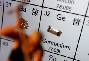 A worker miniature is placed next to the element of Germanium on a periodic table, in this illustration picture taken on July 6, 2023. REUTERS/Florence Lo/Illustration
