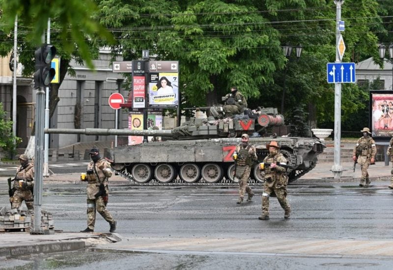 Fighters of Wagner private mercenary group cross a street as they get deployed near the headquarters of the Southern Military District in the city of Rostov-on-Don, Russia, June 24, 2023. REUTERS/Stringer/File Photo