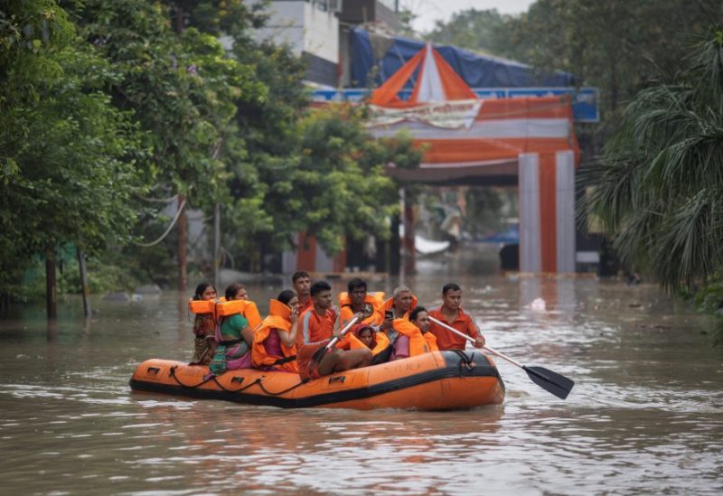 Members of the National Disaster Response Force (NDRF) evacuate stranded residents from a flooded locality, after a rise in the water level of the river Yamuna, in New Delhi, India, July 13, 2023. REUTERS/Adnan Abidi