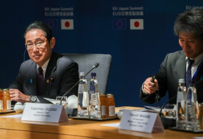 Japanese Prime Minister Fumio Kishida and Deputy Chief Cabinet Secretary Yoshihiko Isozaki prepare for the beginning of the 29th EU-Japan summit in Brussels, Belgium, on 13 July 2023. OLIVIER MATTHYS/Pool via REUTERS/File Photo