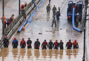 Rescue workers look for victims during a search and rescue operation near an underpass that has been submerged by a flooded river caused by torrential rain in Cheongju, South Korea, July 16, 2023. REUTERS/Kim Hong-ji